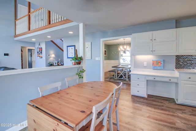 dining area featuring an inviting chandelier and light wood-style flooring