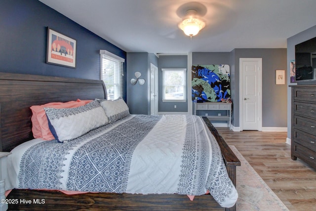 bedroom featuring baseboards and wood finished floors