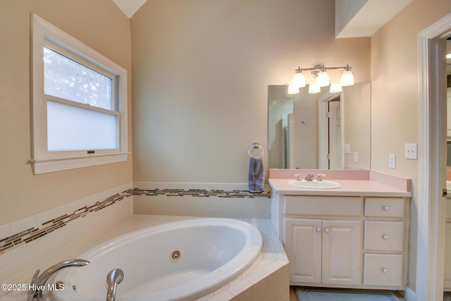 bathroom featuring vanity and a tub with jets