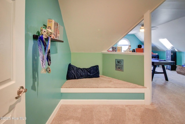 carpeted bedroom with vaulted ceiling and baseboards