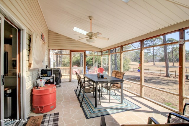 sunroom / solarium featuring lofted ceiling and ceiling fan