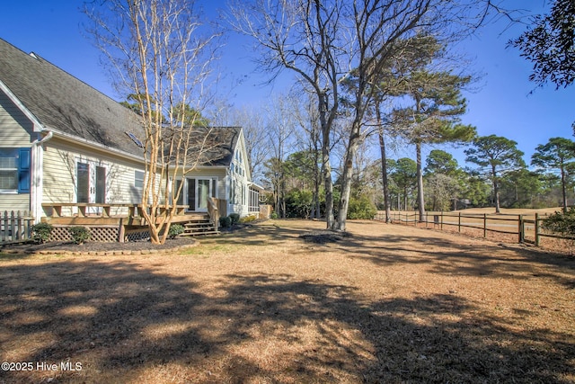 view of yard with fence and a deck