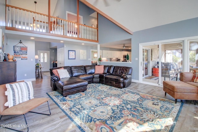 living room featuring wood finished floors, a wealth of natural light, and baseboards