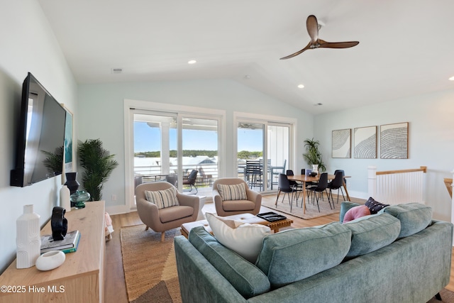 living room featuring wood finished floors, ceiling fan, lofted ceiling, and a healthy amount of sunlight