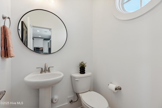 half bathroom with a sink and toilet
