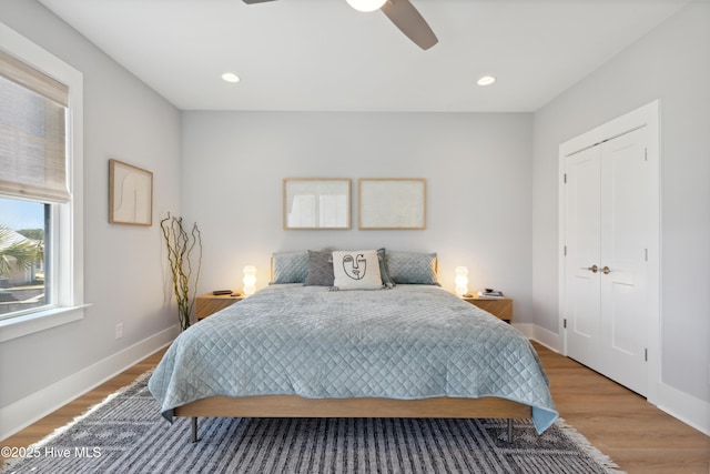 bedroom with ceiling fan, recessed lighting, baseboards, wood finished floors, and a closet