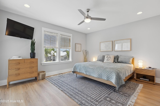 bedroom with light wood-type flooring, recessed lighting, and baseboards