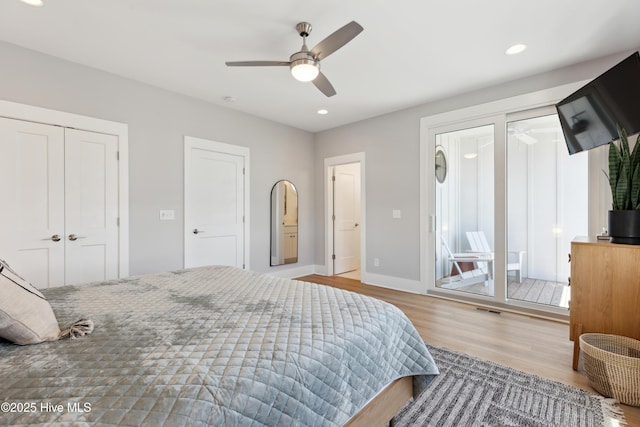 bedroom featuring multiple closets, recessed lighting, a ceiling fan, wood finished floors, and baseboards