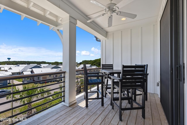 wooden terrace featuring a residential view and a ceiling fan