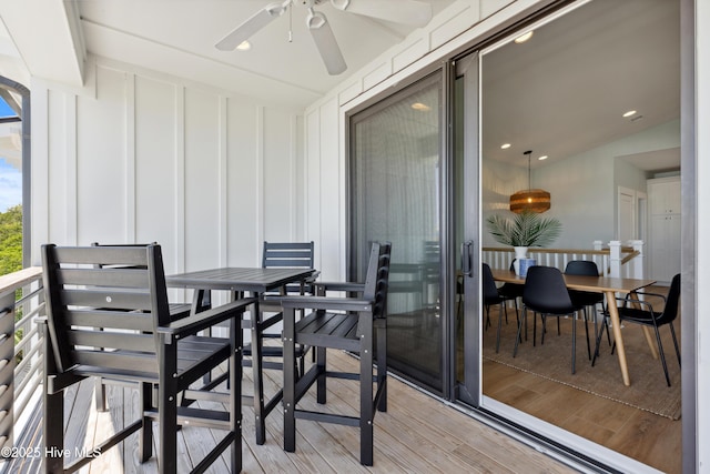 balcony with outdoor dining area and a ceiling fan