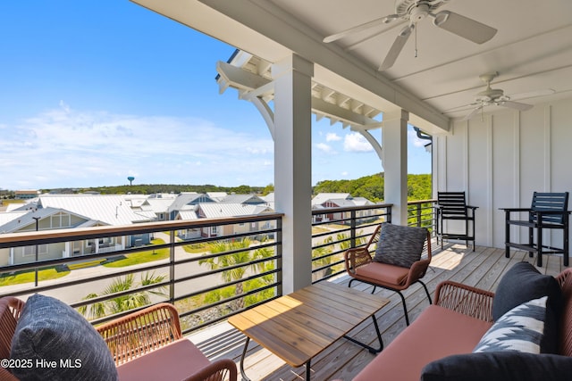 deck featuring ceiling fan, a residential view, and an outdoor hangout area