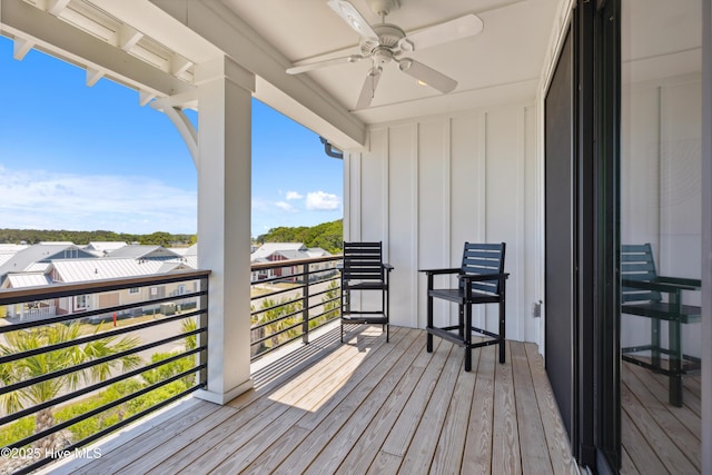 wooden deck featuring a ceiling fan