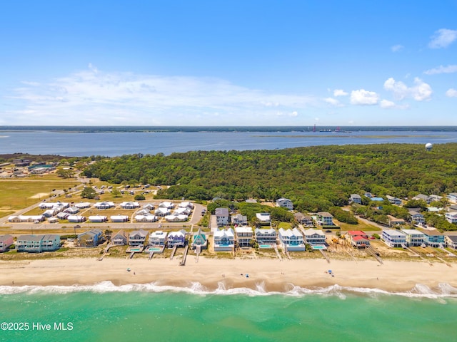 birds eye view of property featuring a water view and a beach view