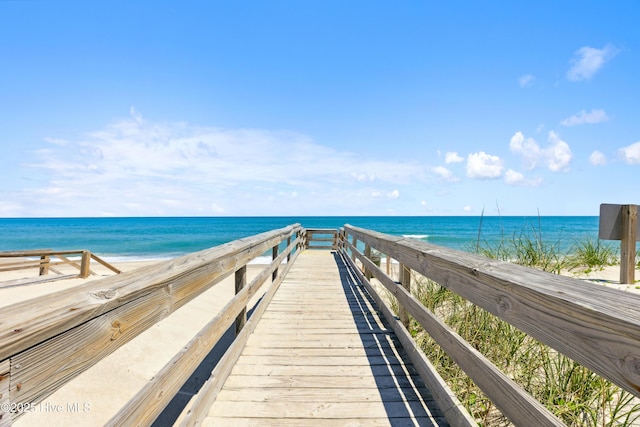 view of property's community featuring a water view and a view of the beach