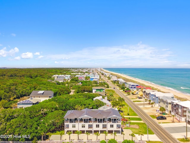 drone / aerial view featuring a water view and a view of the beach