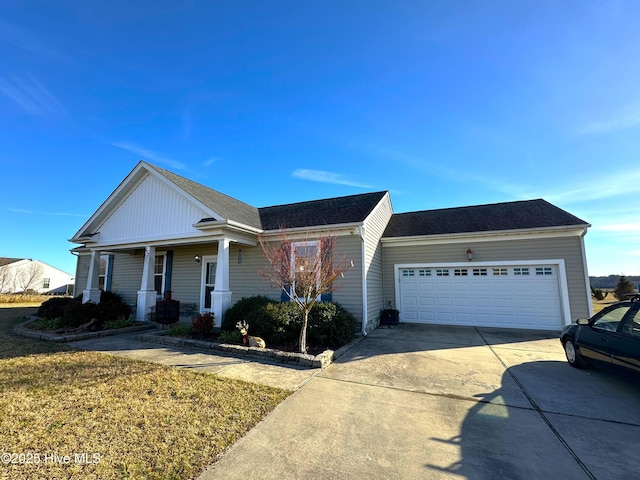 view of front of house featuring a garage, a front lawn, and a porch