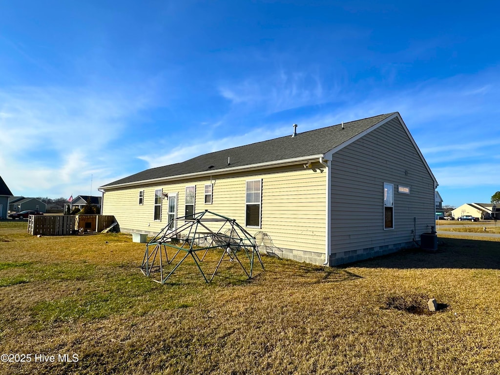 rear view of house with a gazebo, a lawn, and central air condition unit