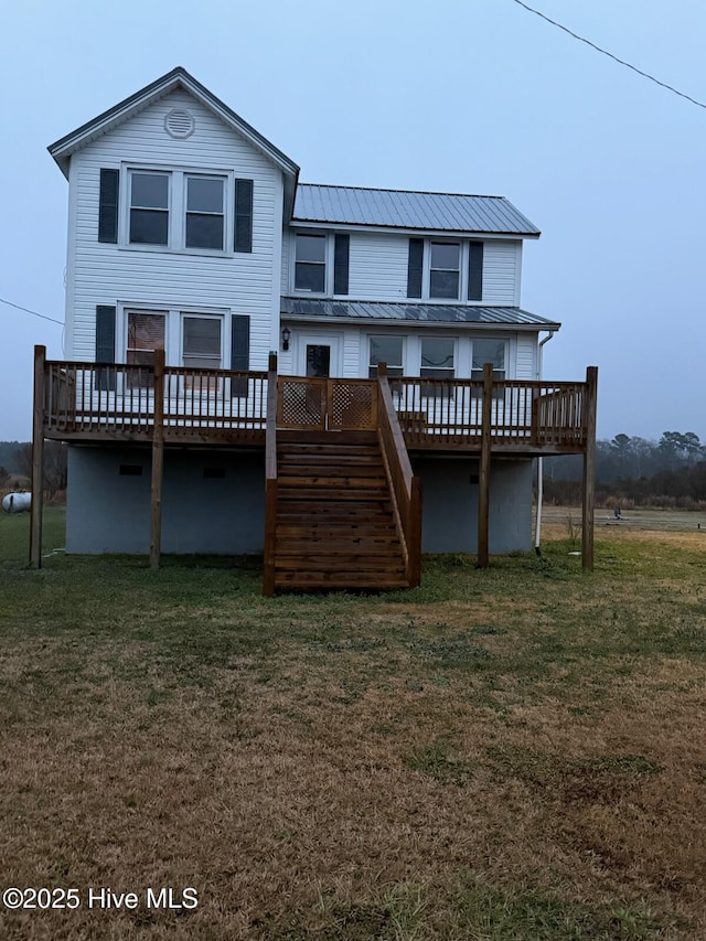 back of property with a yard and a deck