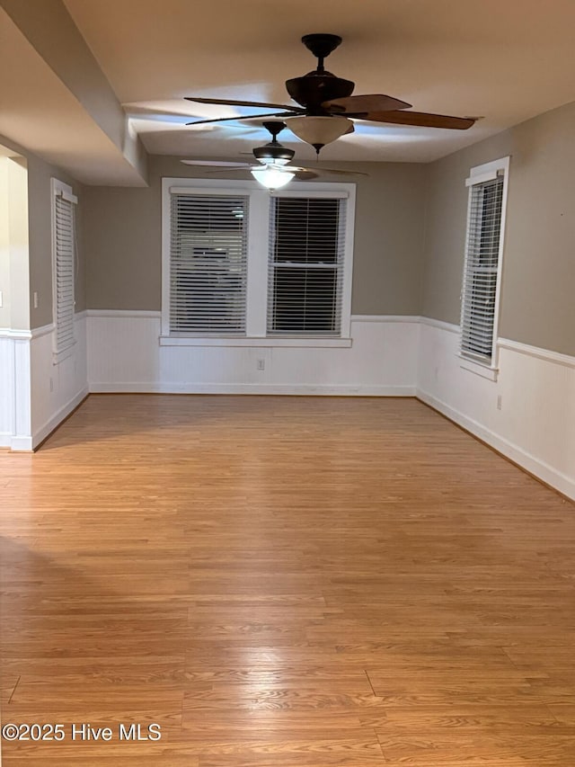 unfurnished room featuring ceiling fan and light wood-type flooring