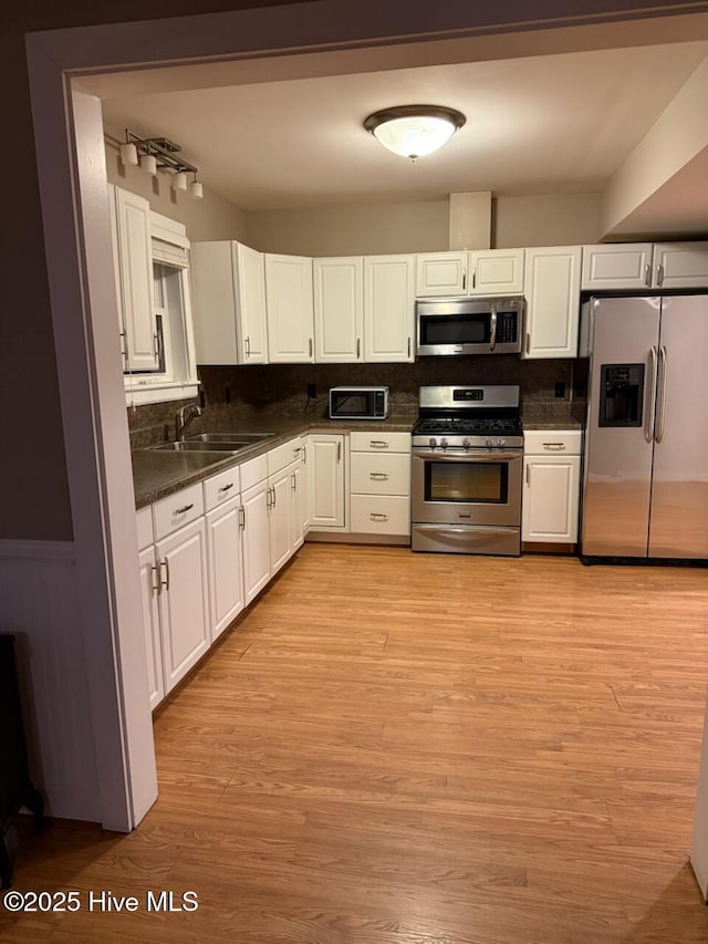 kitchen with white cabinetry, appliances with stainless steel finishes, and sink