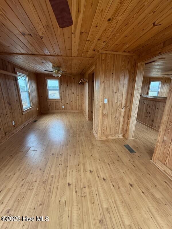 unfurnished room with wooden ceiling and light wood-type flooring