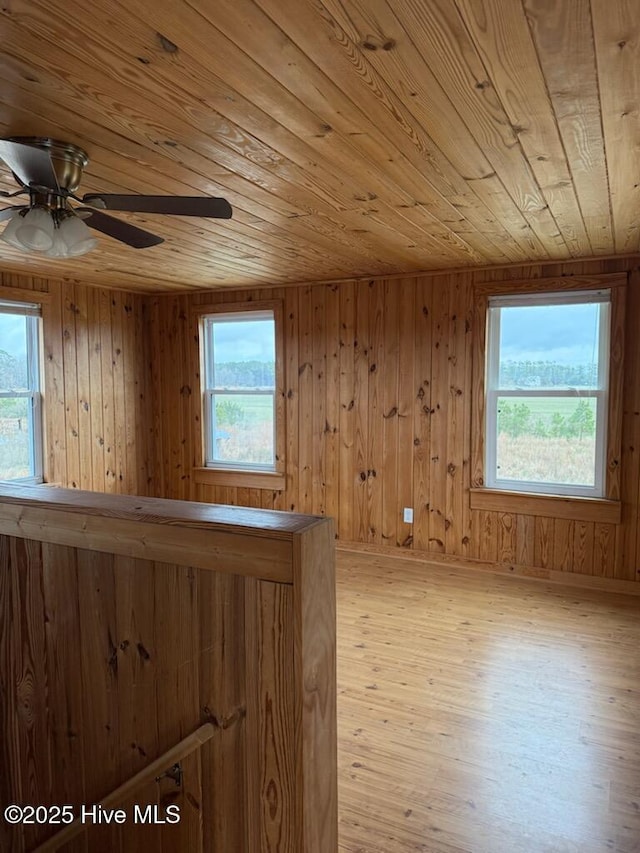 additional living space featuring ceiling fan, a healthy amount of sunlight, wood ceiling, and light hardwood / wood-style floors