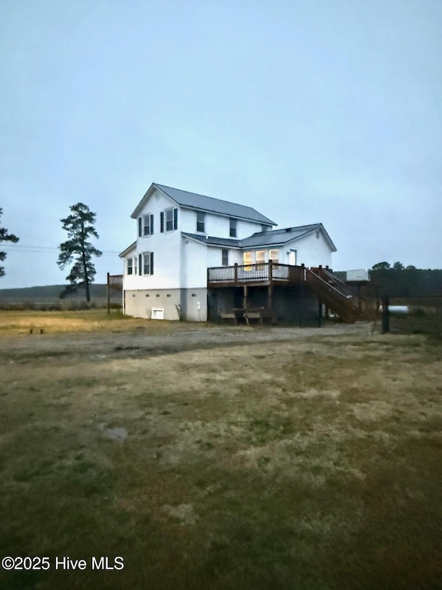 rear view of property with a wooden deck