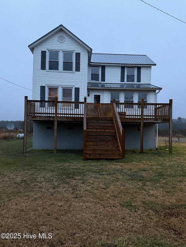 back of house with a wooden deck and a yard