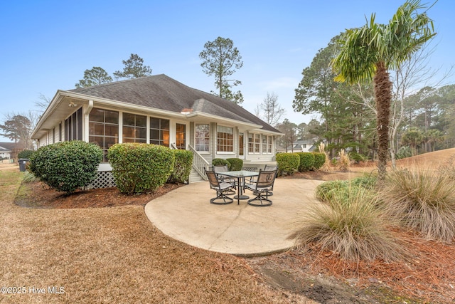 rear view of house featuring a patio area and a sunroom