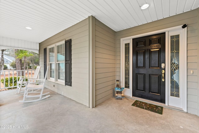 view of exterior entry featuring a porch