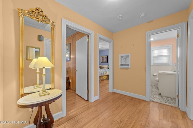 hall featuring baseboards and wood finished floors