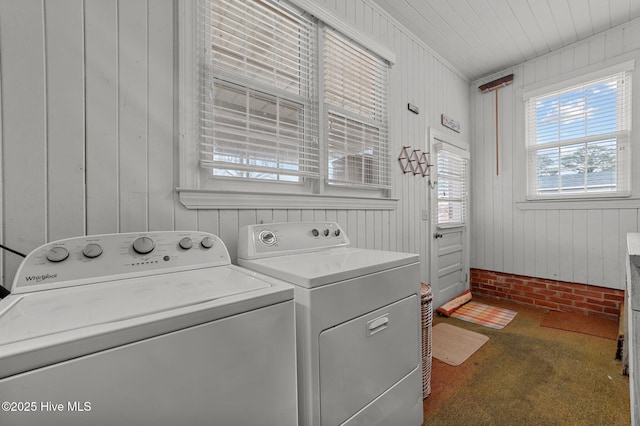 washroom featuring carpet, laundry area, independent washer and dryer, and wooden walls