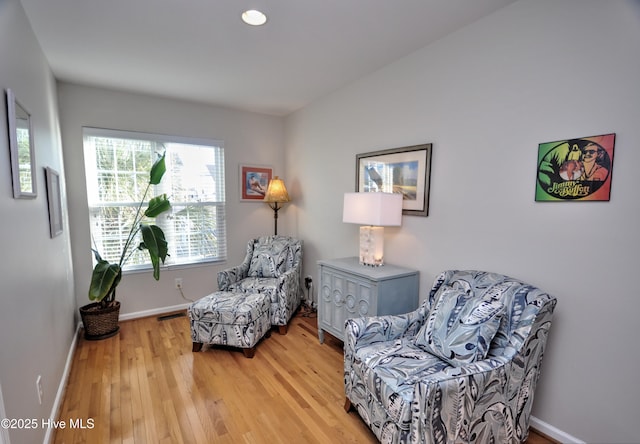 sitting room with wood finished floors and baseboards