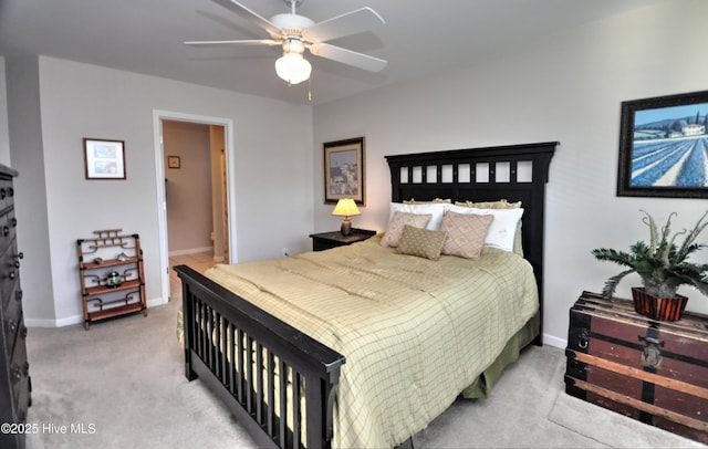 carpeted bedroom with a ceiling fan and baseboards