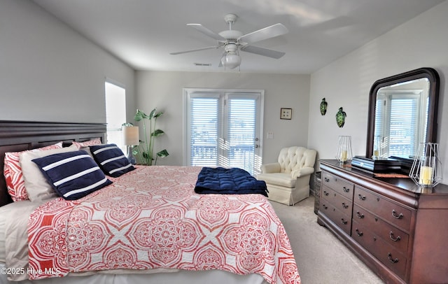 bedroom with ceiling fan, visible vents, and light colored carpet