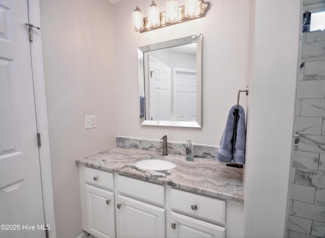 bathroom with marble finish floor and vanity