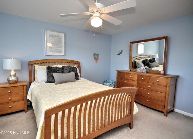 bedroom featuring light carpet, ceiling fan, and baseboards