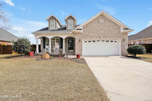 view of front of home featuring driveway, a garage, fence, a porch, and brick siding