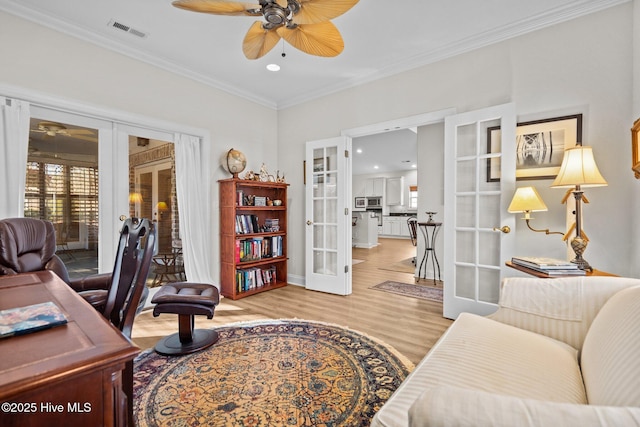 office area featuring ornamental molding, french doors, light wood-type flooring, and visible vents