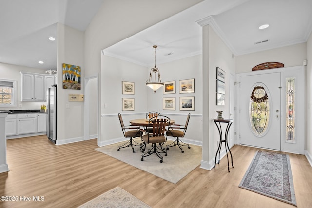 foyer entrance with baseboards, visible vents, crown molding, light wood-type flooring, and recessed lighting