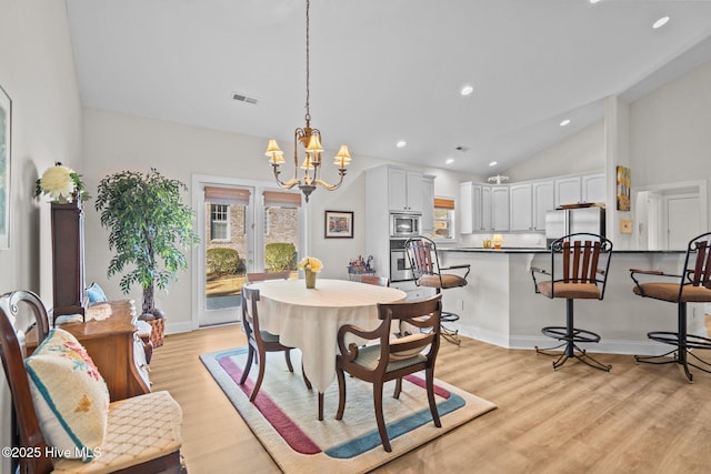 dining room with a chandelier, plenty of natural light, visible vents, and light wood-style floors