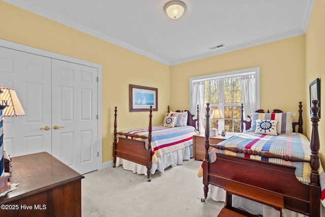 bedroom featuring light carpet, ornamental molding, a closet, and visible vents