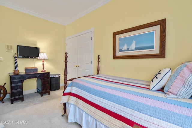 bedroom with crown molding, a closet, and light colored carpet