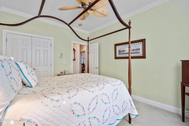 carpeted bedroom with ornamental molding, a closet, baseboards, and a ceiling fan