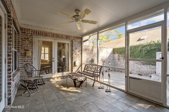 unfurnished sunroom with a ceiling fan