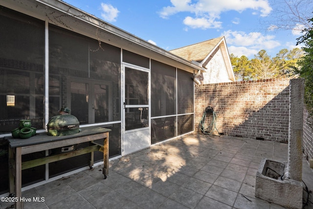 view of patio / terrace with a sunroom and fence