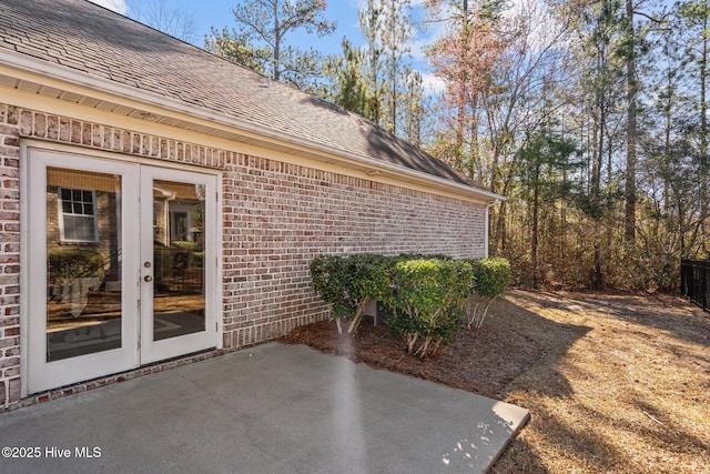 exterior space featuring french doors, brick siding, and a patio