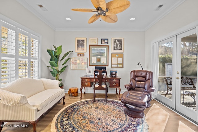 interior space with french doors, visible vents, ornamental molding, wood finished floors, and baseboards