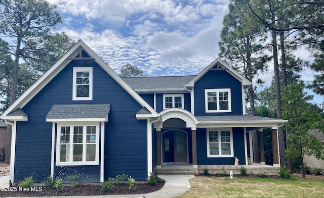 view of front of house with covered porch and a shingled roof