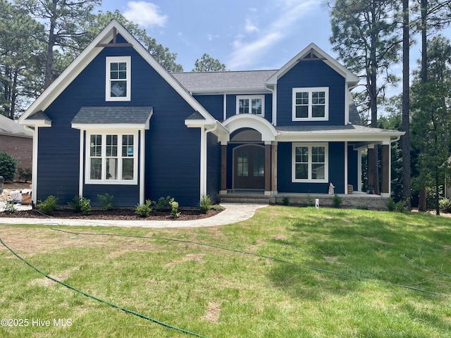 241 Juniper Creek Blvd, Pinehurst, NC 28374 - view of front of property with a front yard, a porch, and a shingled roof